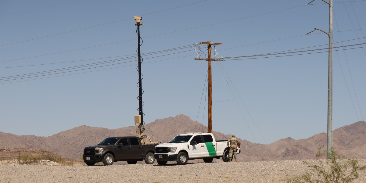A truck with a mobile surveillance tower next to a Border Patrol vehicle